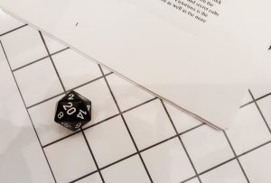 A 20-sided die showing a 20 on its face